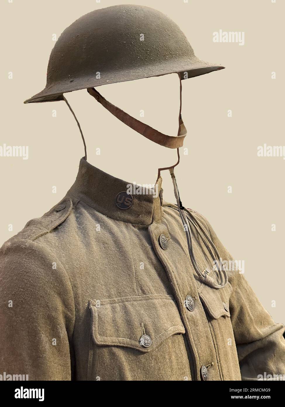 See WWI soldier replica model of man in uniform with collar, lapels, buttons, pockets showing by his chest.He wears a helmet with strap on his head. Stock Photo