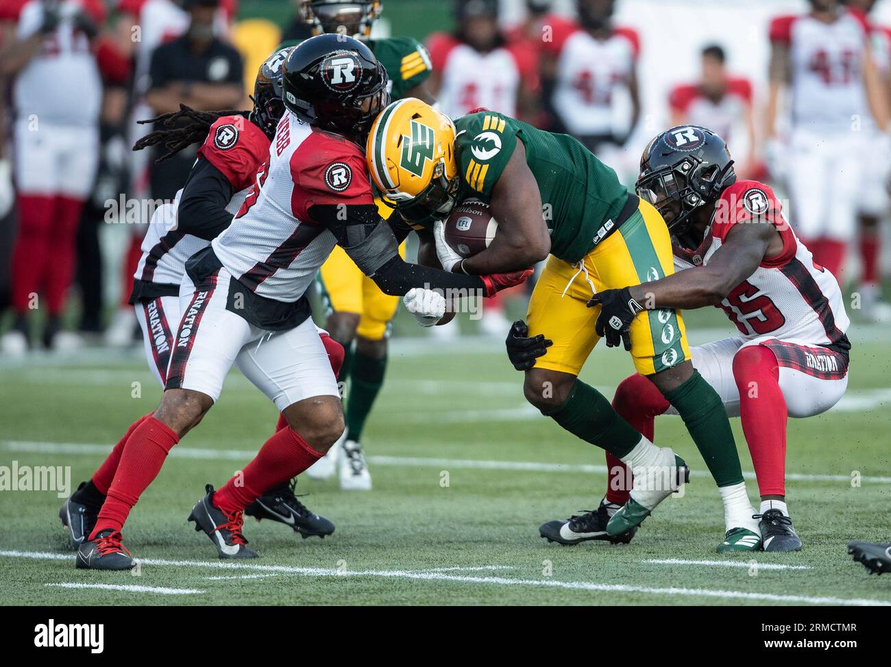 Ottawa Redblacks players tackle Edmonton Elks Kevin Brown (4) during ...