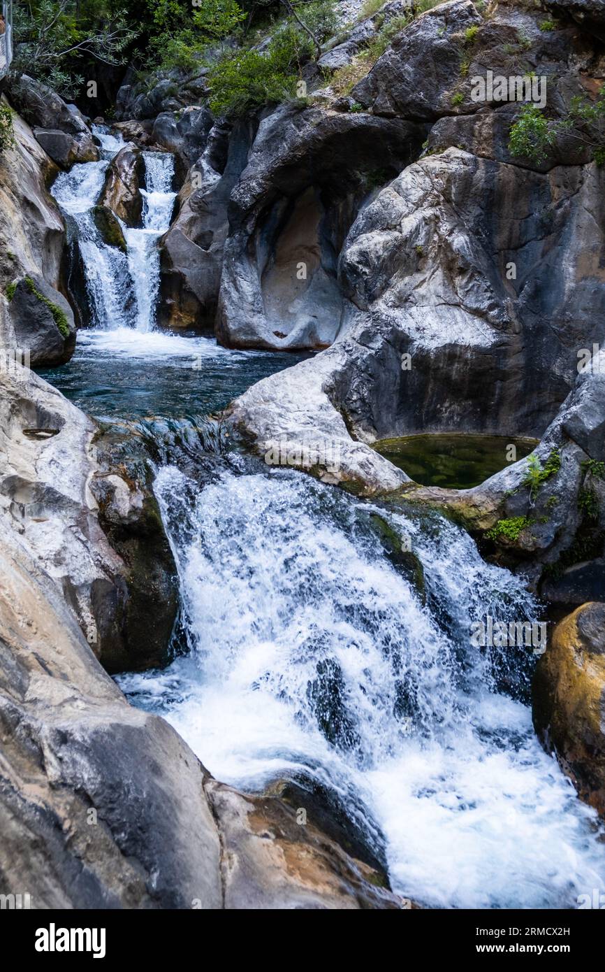 A beautiful mountain gorge with a river and a waterfall Stock Photo - Alamy