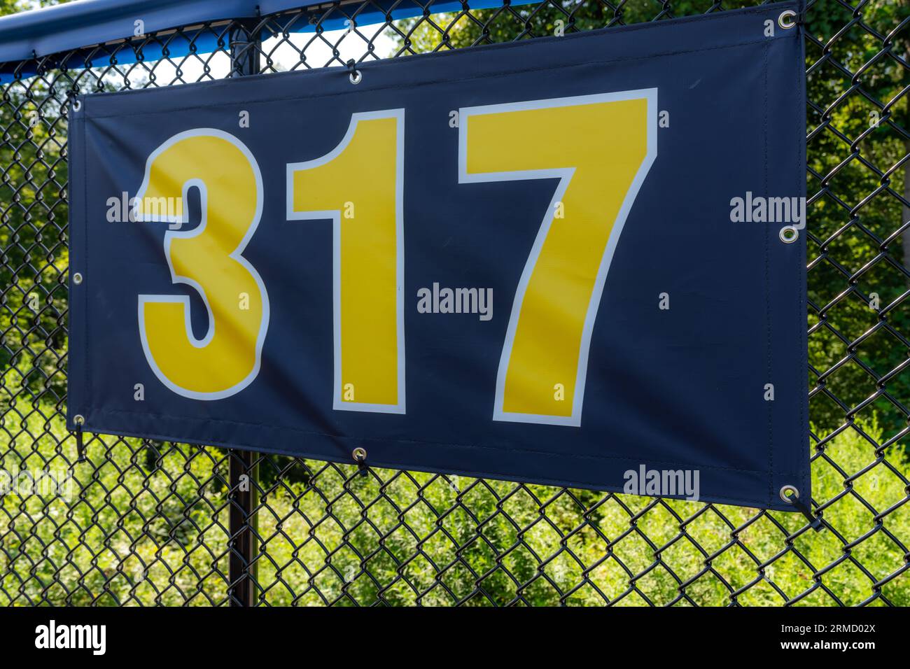 317 foot ft baseball field distance sign in yellow and black mounted on