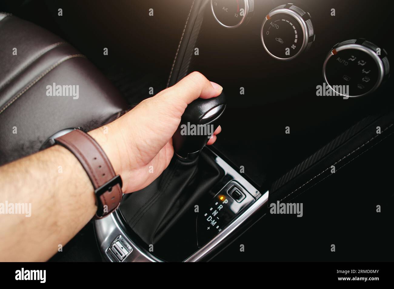 Driver hand holding gear lever of automatic transmission and hand moves