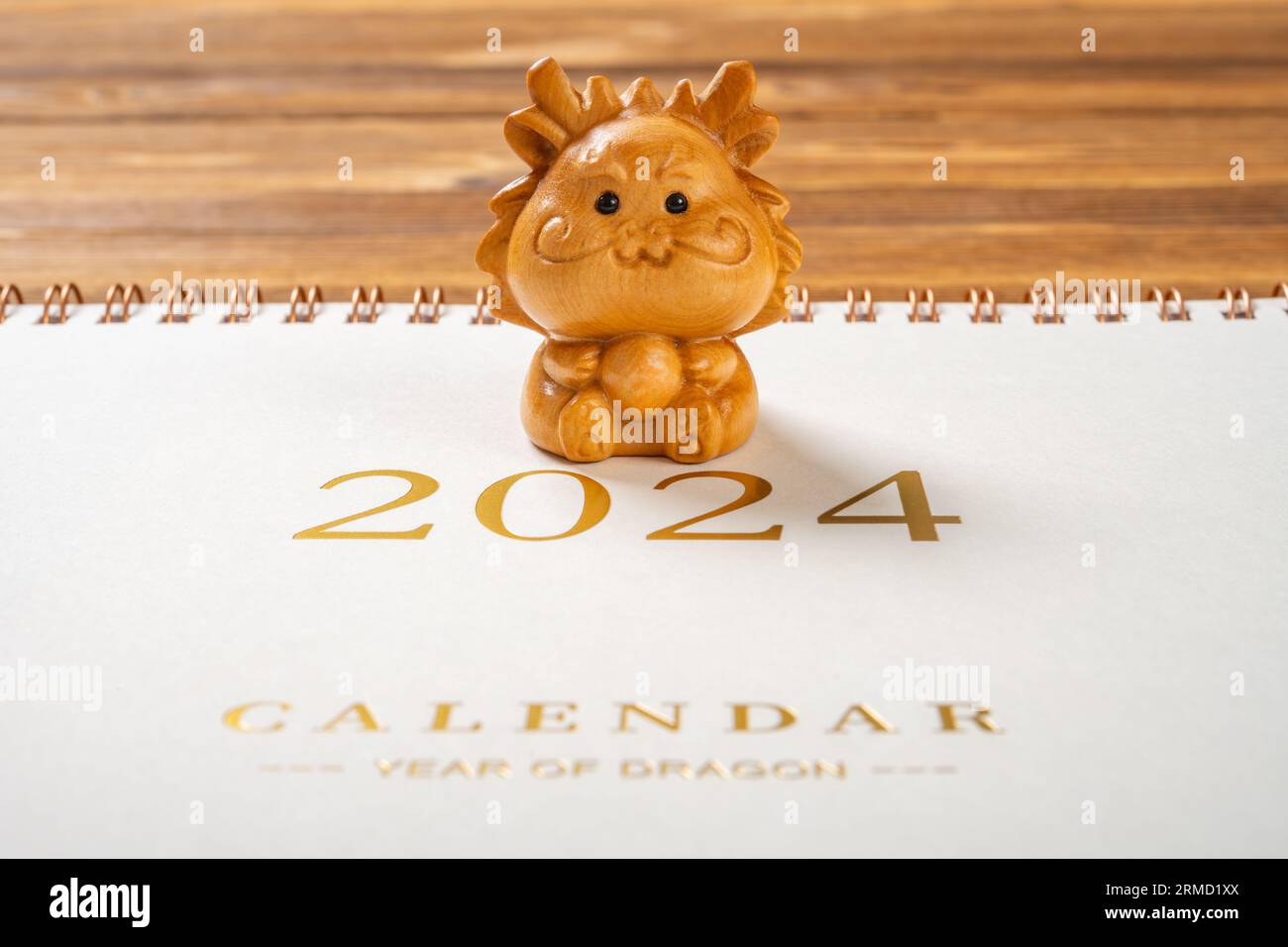 Dragon mascot with a 2024 calendar at horizontal composition no logo no trademark Stock Photo