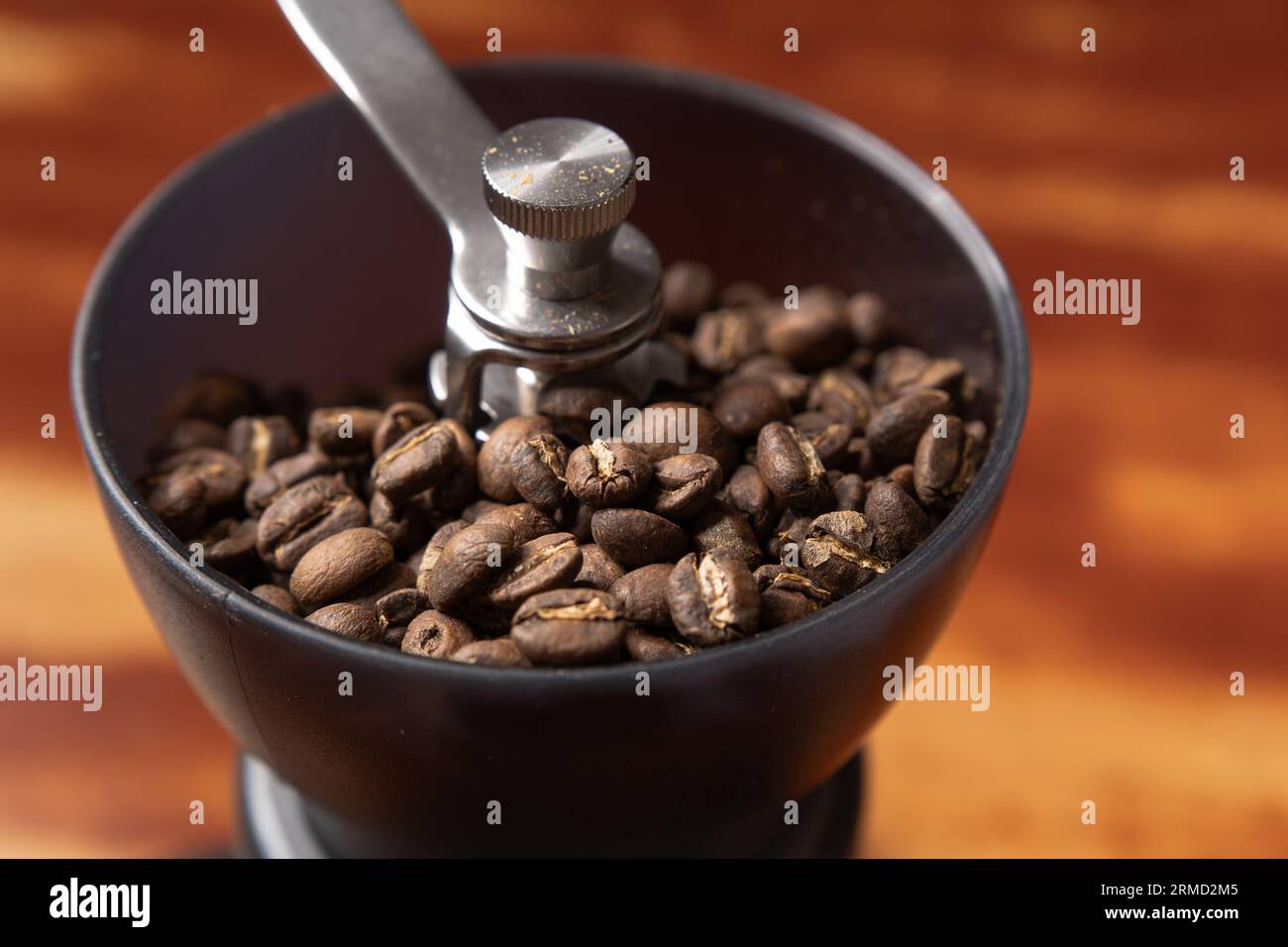 Roasted coffee beans in a coffee grinder Stock Photo