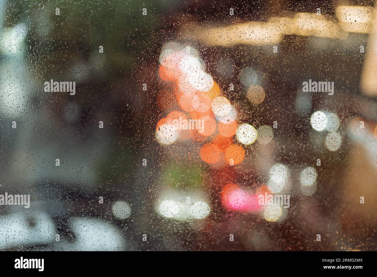 Rain drops on the window with view of traffic jam Stock Photo