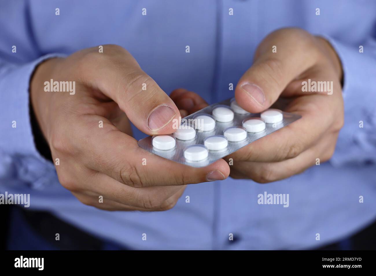 Man in office clothes taking pills, medication close up. Concept of antidepressant, stress at work, vitamins, dose of drugs Stock Photo