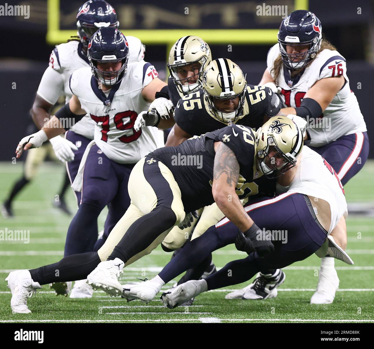 New Orleans, USA. 27th Aug, 2023. Houston Texans offensive tackle Austin  Deculus (76) and center Jarrett Patterson (68) both close in on New Orleans  Saints defensive end Kyle Phillips (91) During a