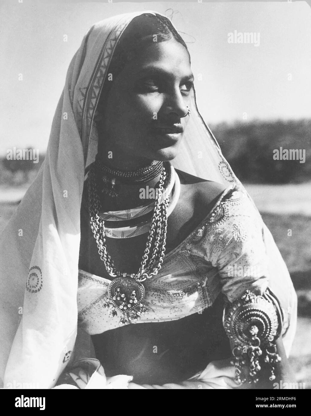 old vintage outdoor portrait black and white early 1900s silver gelatin toned print Indian woman India Stock Photo