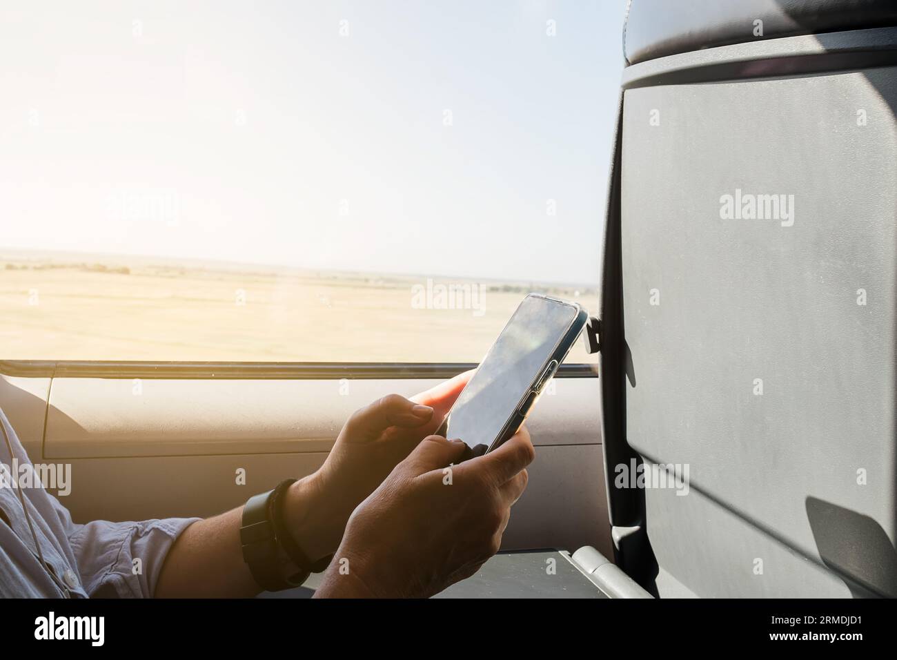 beautiful woman using smart phone while sitting on a train Stock Photo