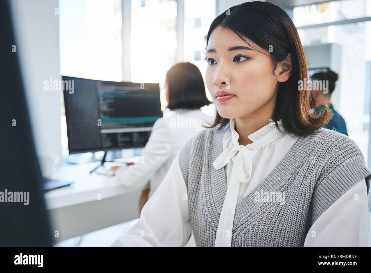 Programming, developer and computer with business woman in office for coding, software and information technology. Database, website and research with Stock Photo