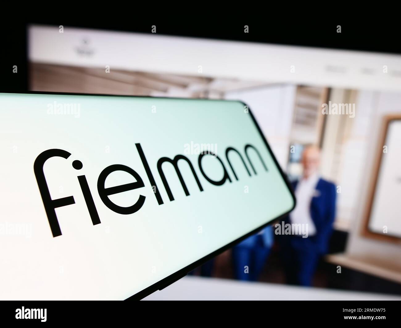 Smartphone with logo of German eyewear company Fielmann AG on screen in ...