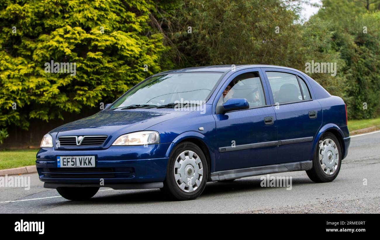 Whittlebury,Northants,UK -Aug 26th 2023:  2004 blue Vauxhall Astra car travelling on an English country road Stock Photo