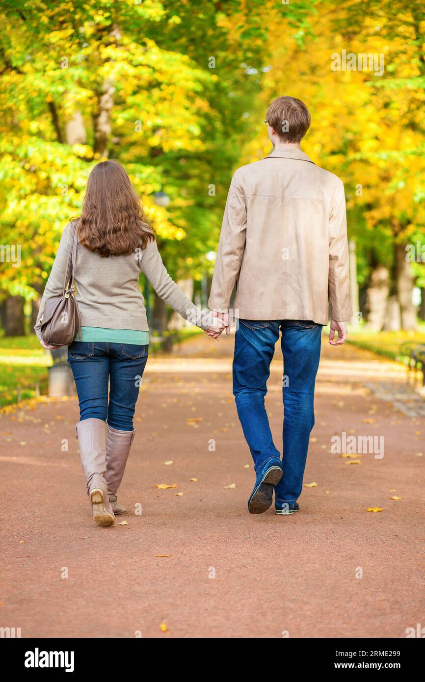 Couple in love walking together in park on a fall day Stock Photo - Alamy
