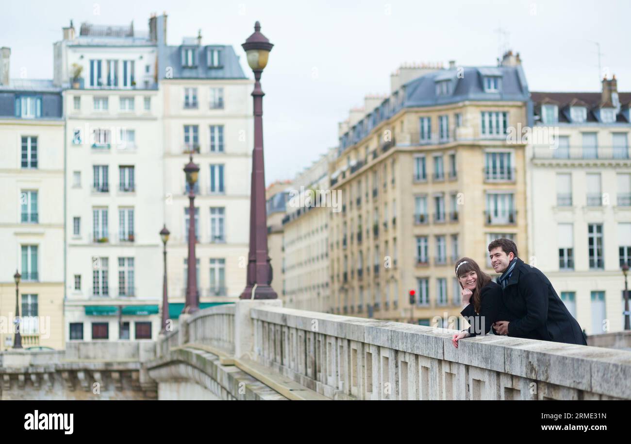 Couple on a Parisian bridge Stock Photo - Alamy