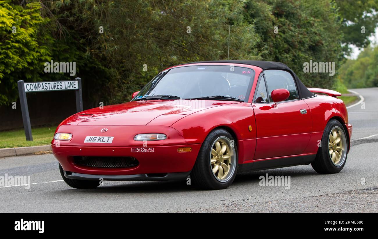 Whittlebury,Northants,UK -Aug 26th 2023:1991 red Mazda MX 5 sports  car travelling on an English country road Stock Photo