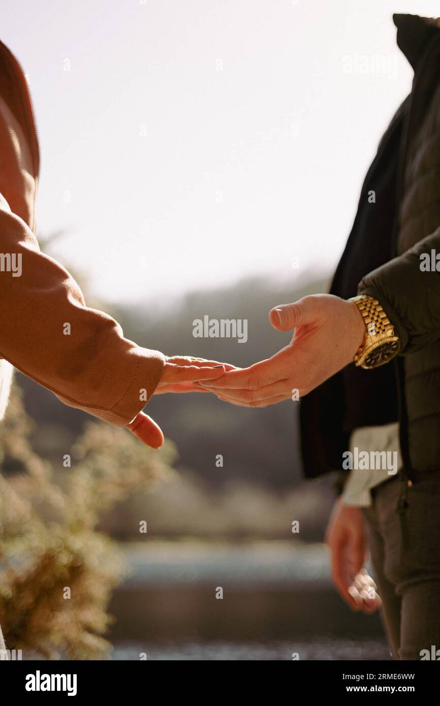 Loving couples' hands touch in a glowing golden light Stock Photo Alamy