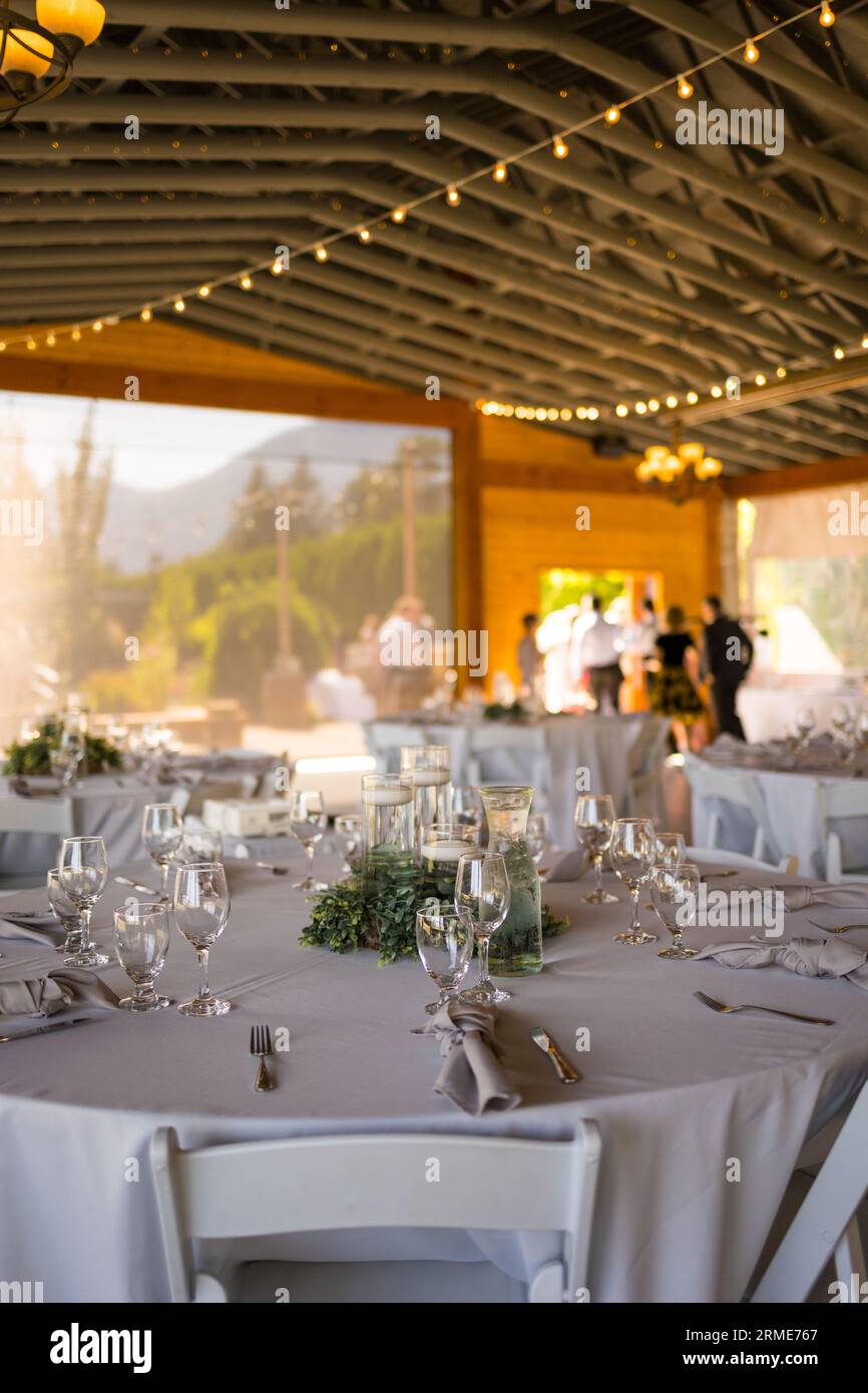 Charming table set up awaits guests at rustic barn wedding Stock Photo