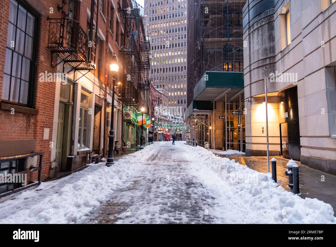 Snow On The Cobblestones Of Stone Street In Lower Manhattan Stock Photo snow-on-the-cobblestones-of-stone-street-in-lower-manhattan-stock-photo