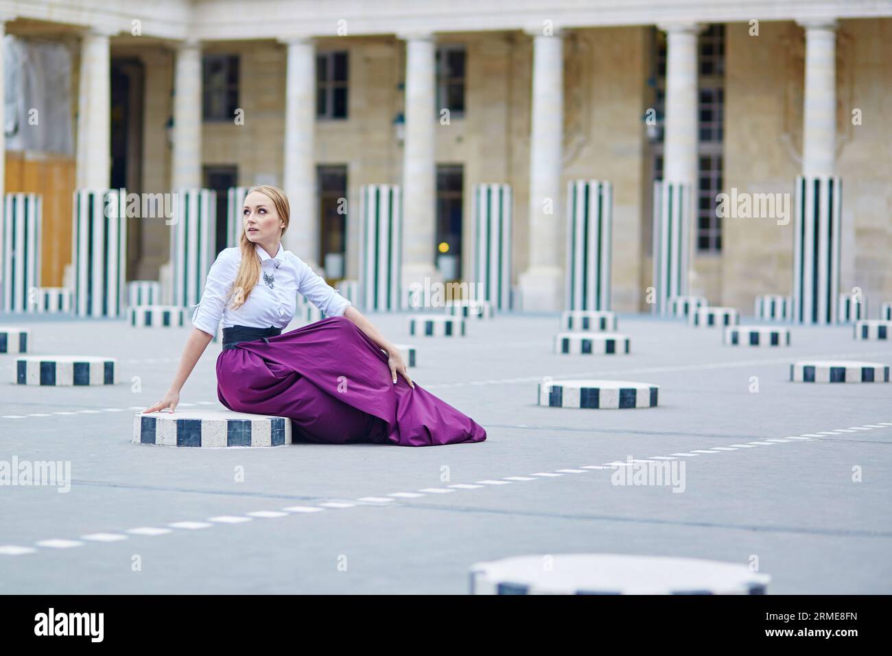 eautiful young woman in long skirt Palais Royal in Paris Stock Photo