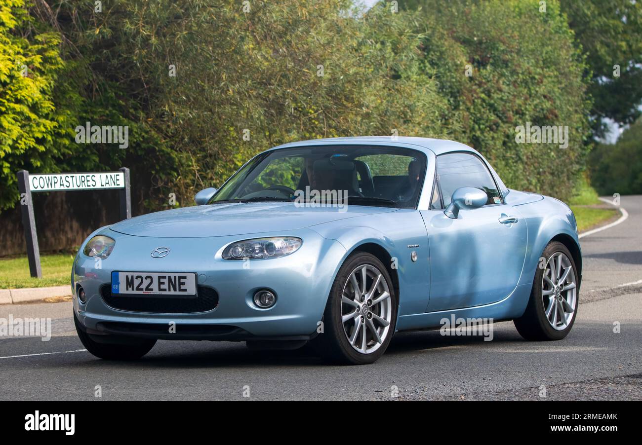 Whittlebury,Northants,UK -Aug 26th 2023: 2008 blue Mazda MX 5 niseko roadster coupe car travelling on an English country road Stock Photo