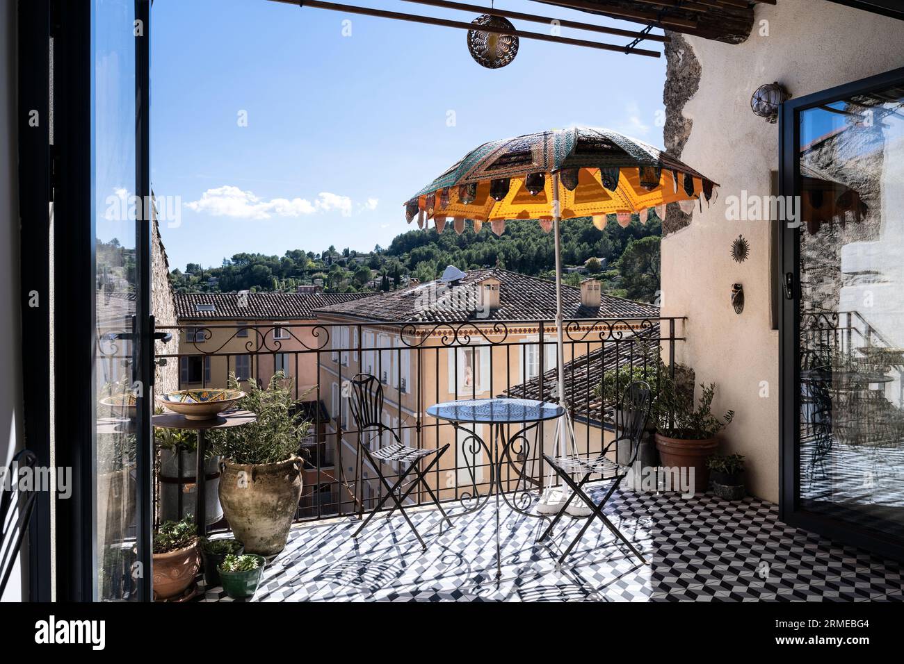 Indian parasol on balcony with view over town of Cotignac, Var, Provence-Alpes-Cote d'Azur, France. Stock Photo