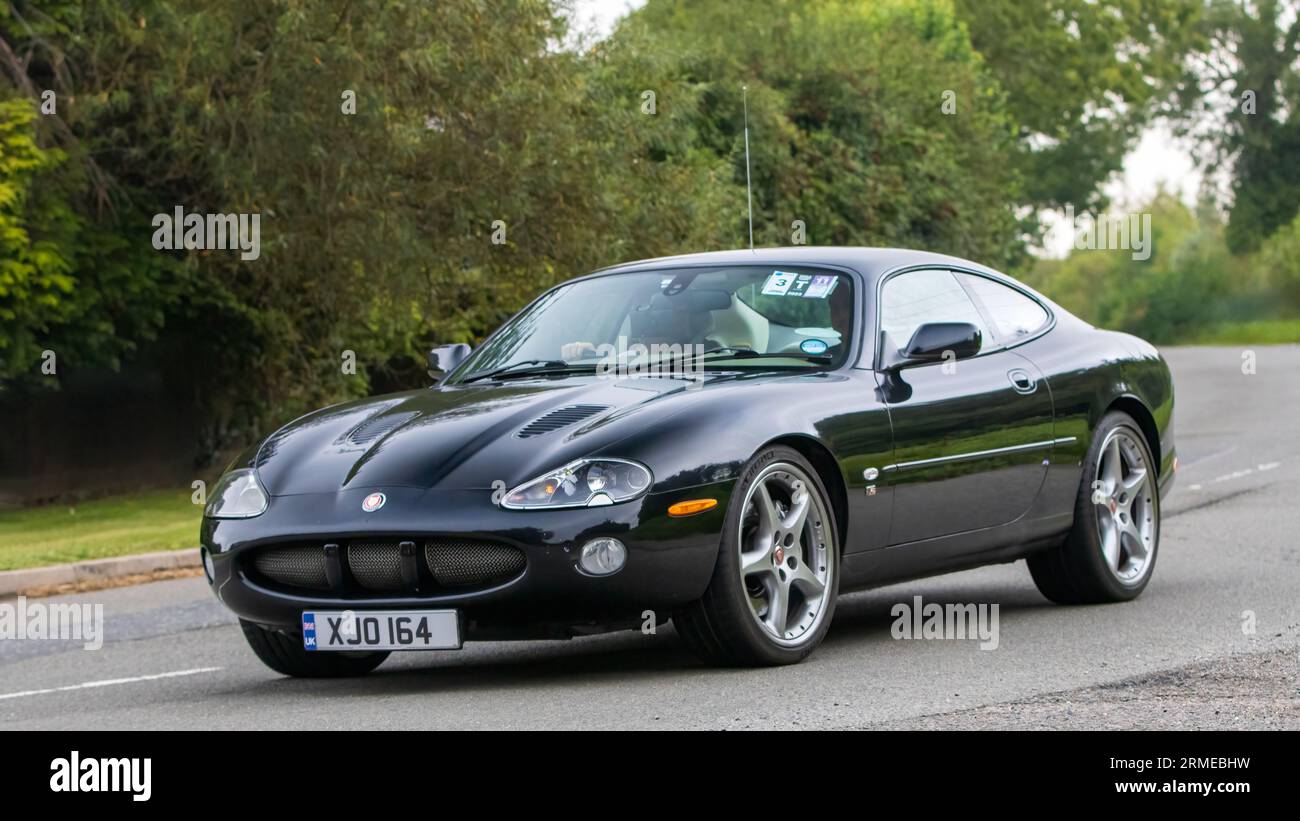 Whittlebury,Northants,UK -Aug 26th 2023: 2003 black Jaguar XKR car travelling on an English country road Stock Photo