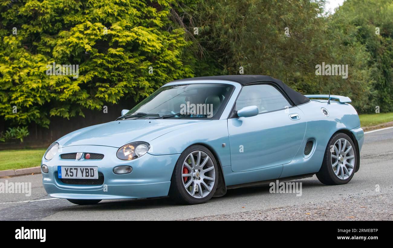 Whittlebury,Northants,UK -Aug 26th 2023: 2000 blue MG MGF sports car travelling on an English country road Stock Photo