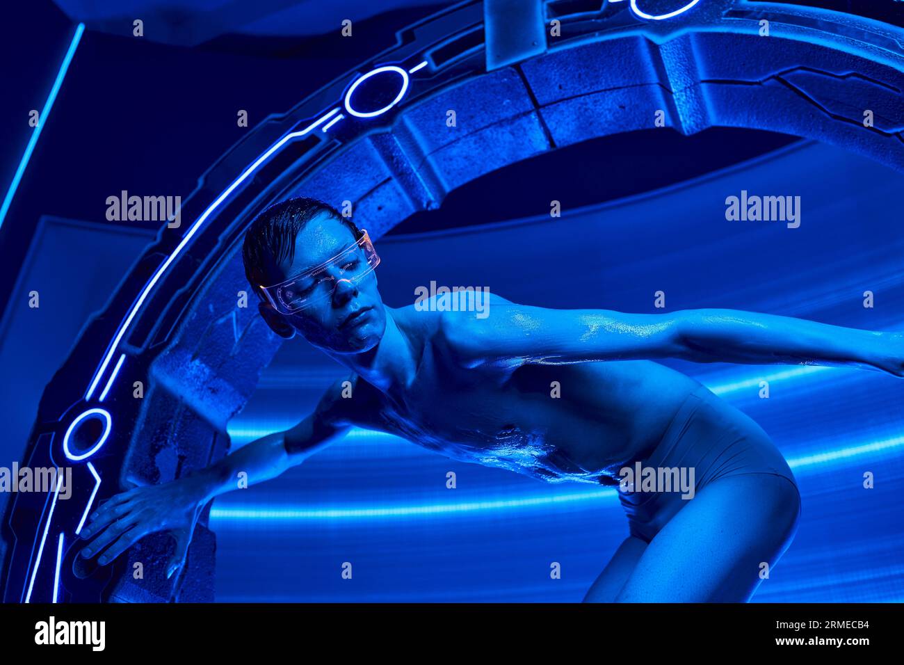 futuristic science, humanoid alien in goggles near high-tech equipment in discovery center Stock Photo