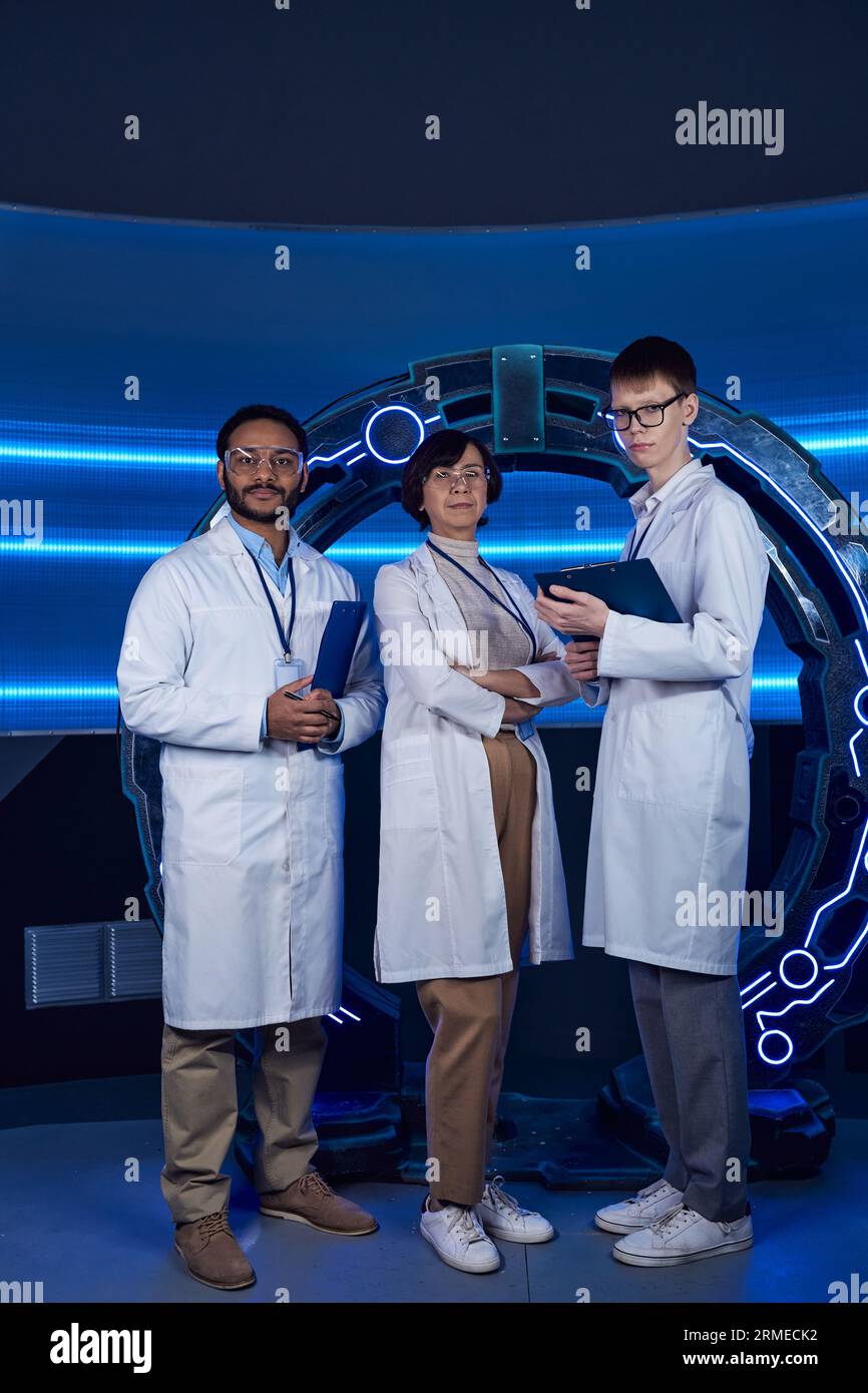 futuristic laboratory, multiethnic team of scientists looking at camera near high-tech equipment Stock Photo