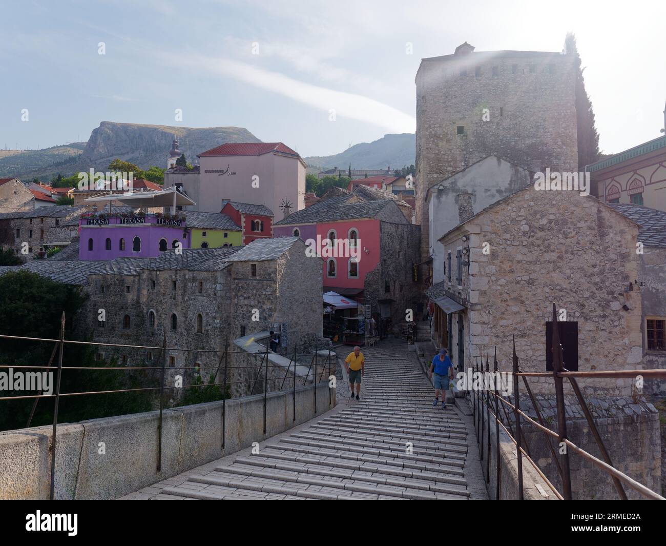 Stari Most (Old Bridge) and Mostar old town Unesco site with cobbled streets and colourful properties. Bosnia and Herzegovina, August 28, 2023. Stock Photo