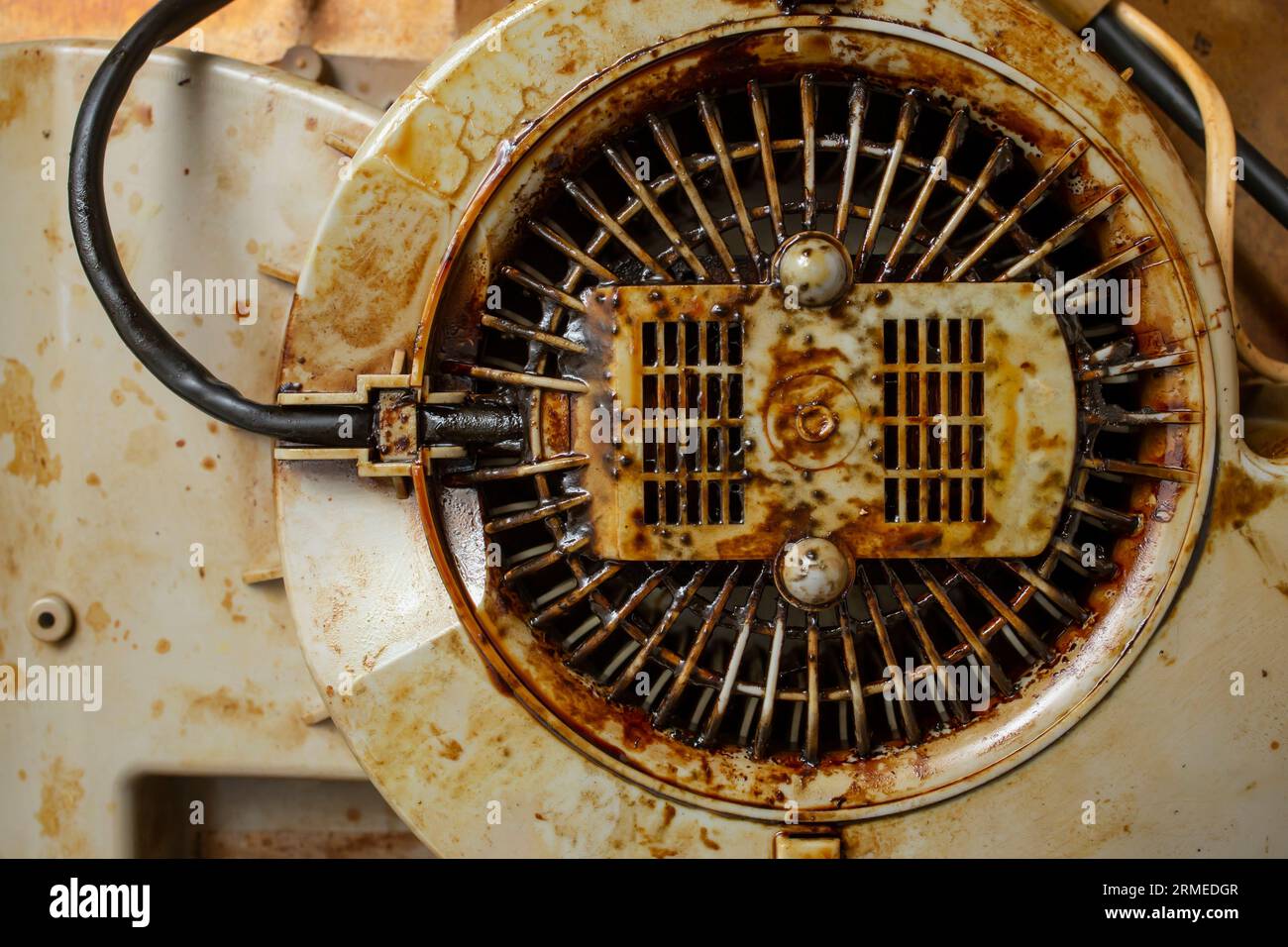 Dirty with burned grease cooker hood filter fan motor, soft focus Stock Photo