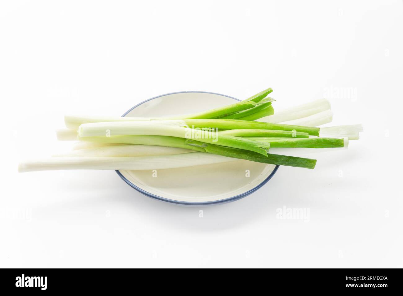 Green onions on a white background Stock Photo - Alamy