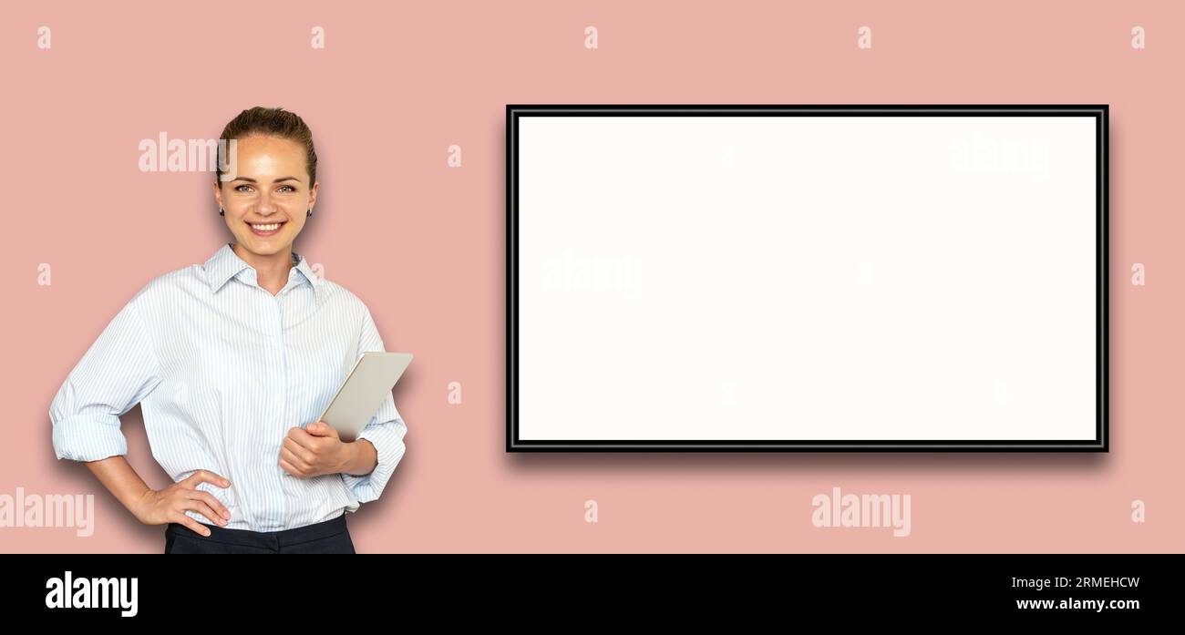 Isolated female business person standing next to slideshow digital screen. Stock Photo