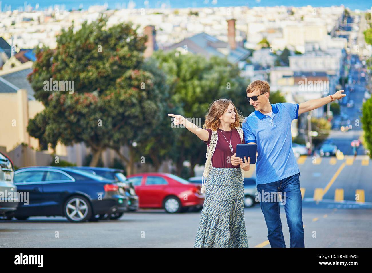 Romantic couple of tourists using tablet and planning their itinerary in San Francisco, California, USA Stock Photo