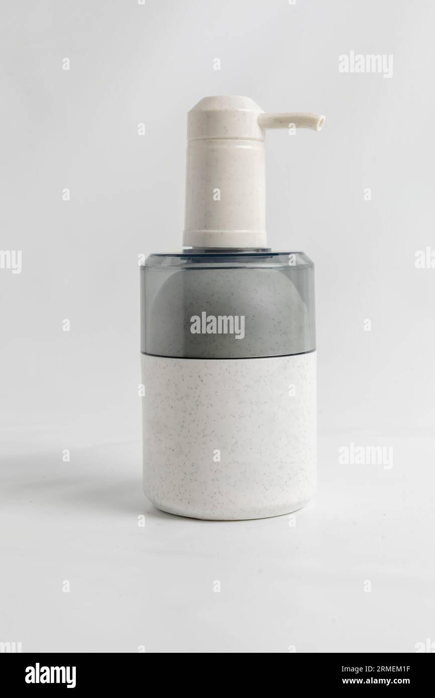Shampoo dosing bottle on white Stock Photo - Alamy