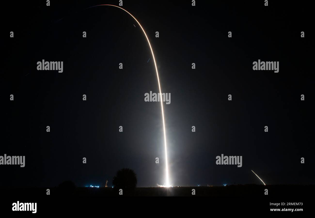 In this eight-minute long exposure, a SpaceX Falcon 9 rocket carrying the company's Dragon spacecraft is launched on NASAâs SpaceX Crew-7 mission to the International Space Station with NASA astronaut Jasmin Moghbeli, ESA (European Space Agency) astronaut Andreas Mogensen, Japan Aerospace Exploration Agency (JAXA) astronaut Satoshi Furukawa, and Roscosmos cosmonaut Konstantin Borisov onboard, Saturday, Aug. 26, 2023, at NASAâs Kennedy Space Center in Florida. Also visible in this image is the entry burn and landing burn, at right, conducted by the first stage of the Falcon 9 rocket as it r Stock Photo