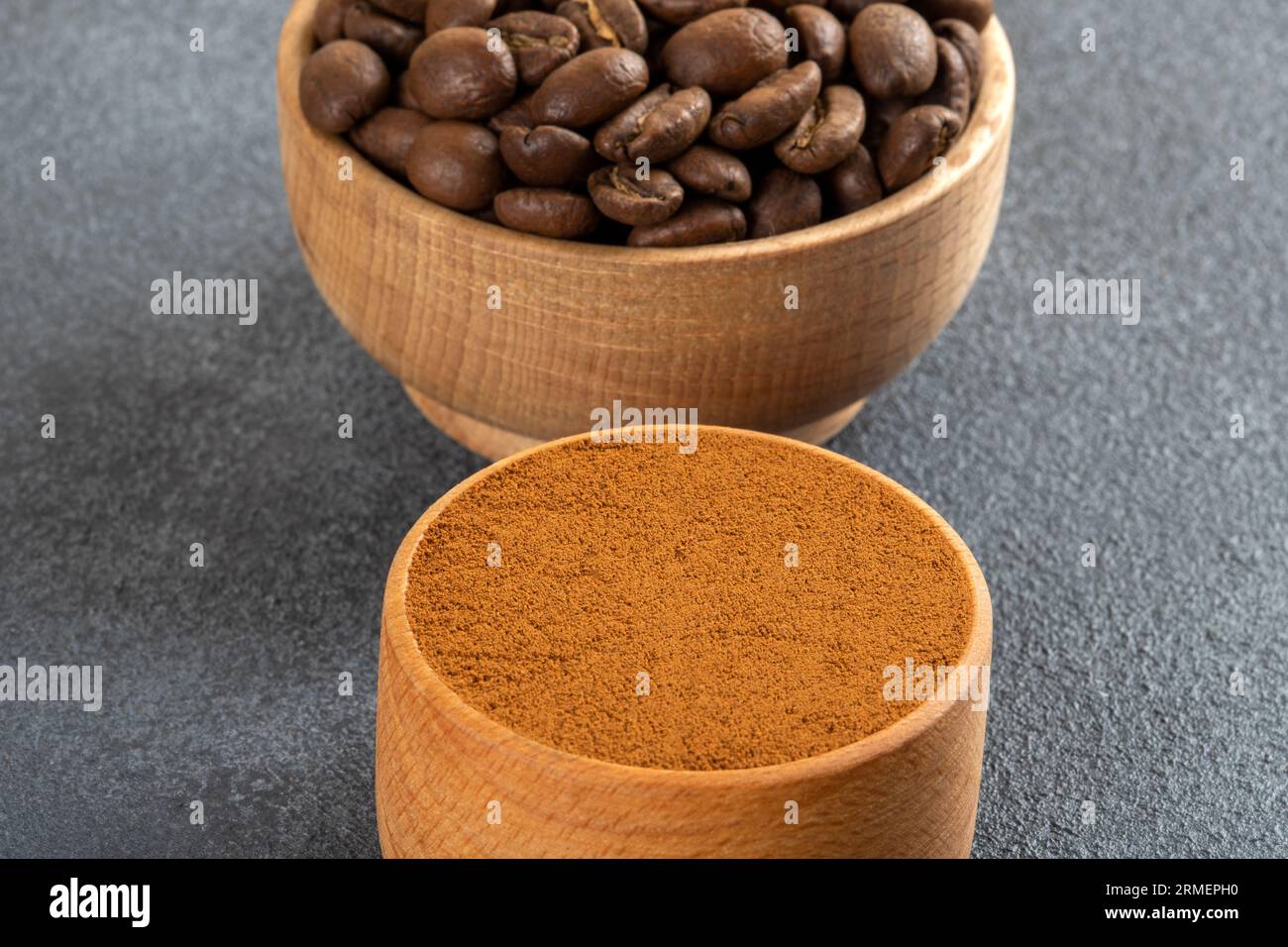 Coffee beans with a bowl of ground coffee ,closeup Stock Photo