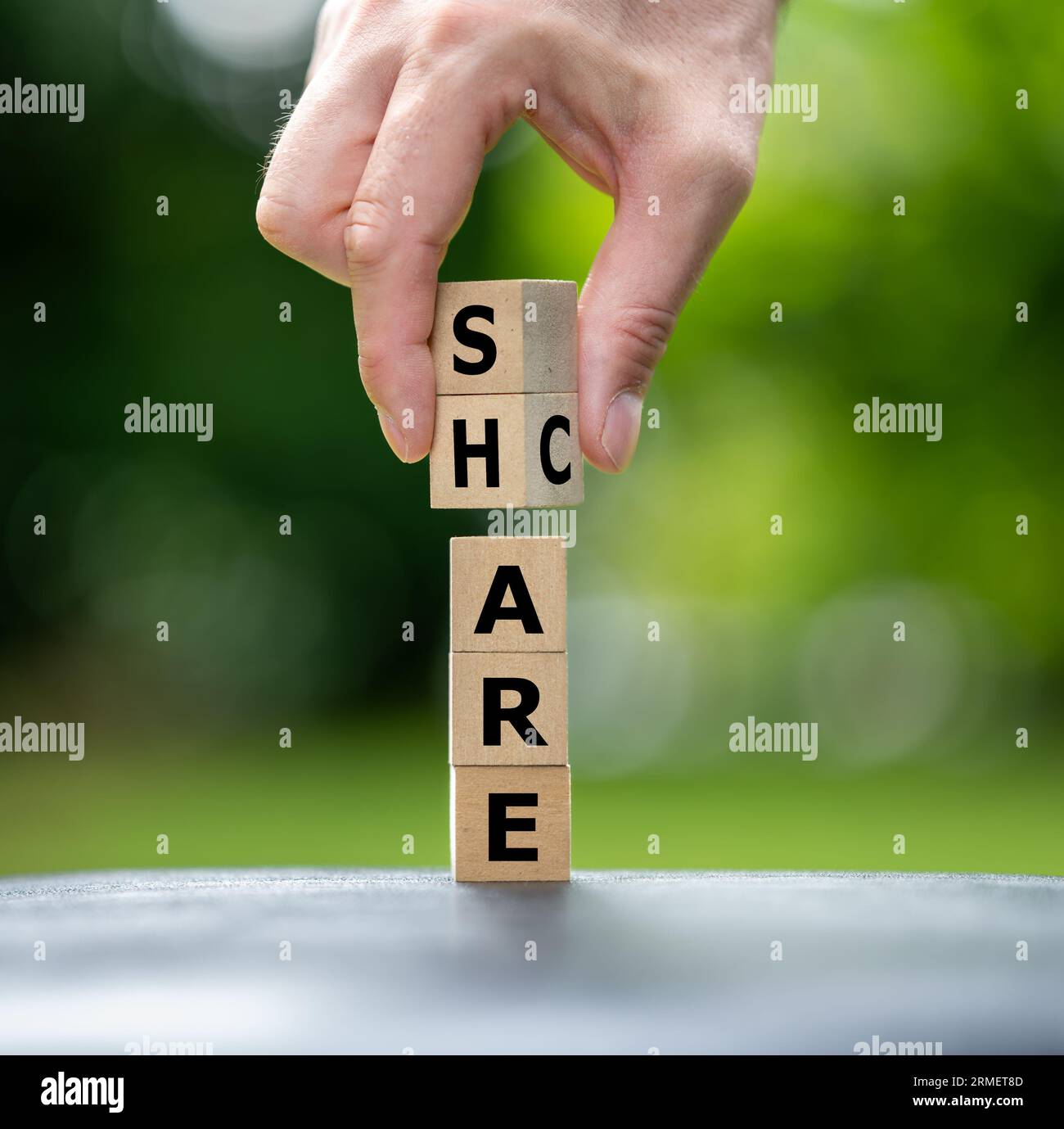 A stack of wooden cubes form the words care and share Stock Photo Alamy