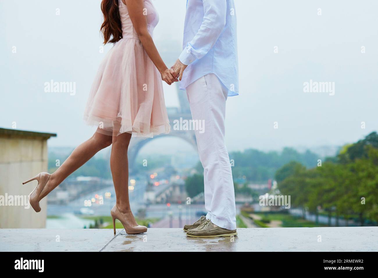 Couple having a date, holding hands and kissing or hugging in front of ...