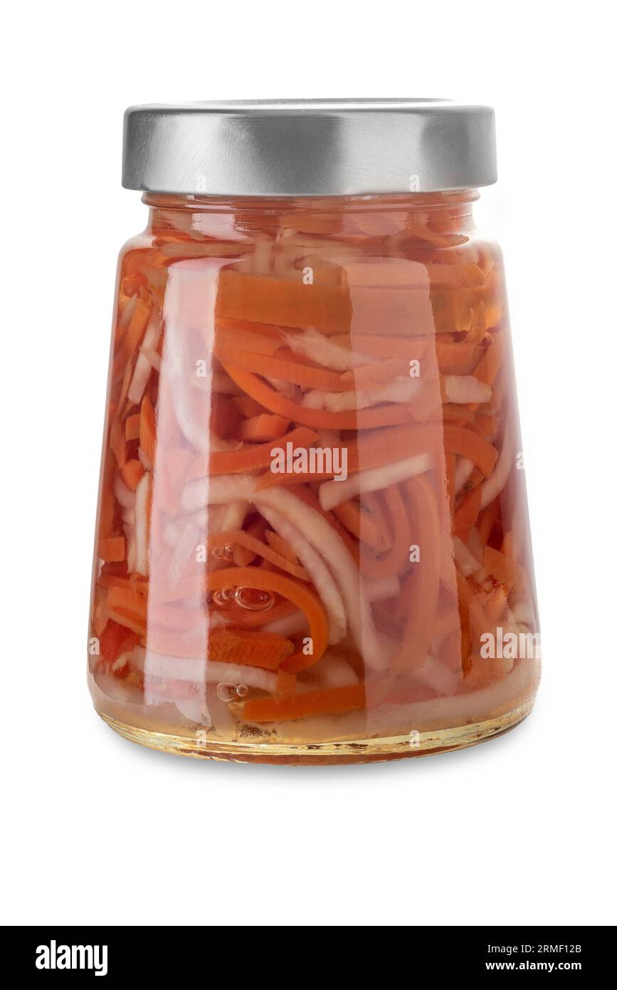A mixture of julienne-cut pickled vegetables in a glass jar, in Italian called giardiniera: an ingredient for Russian salad. Isolated on white, clippi Stock Photo