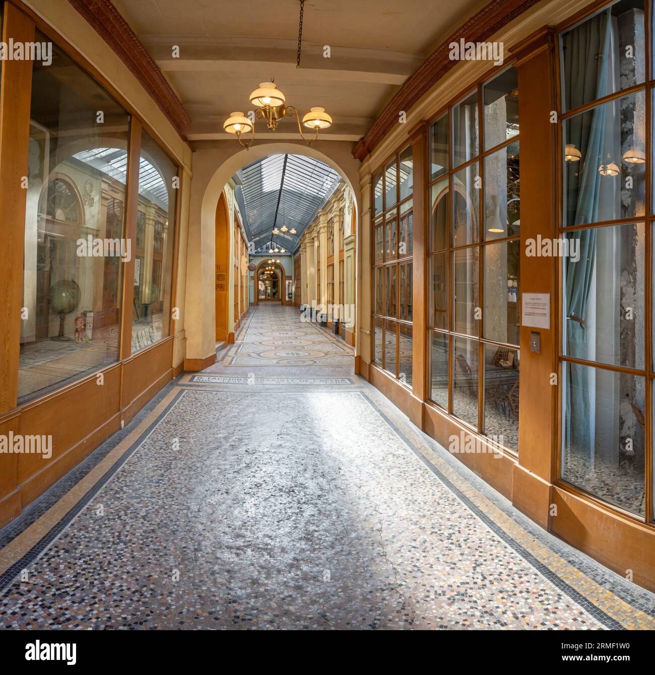 Paris, France - 08 26 2023: Vivienne passage. View of an alley from the passage with mosaics on the floor Stock Photo