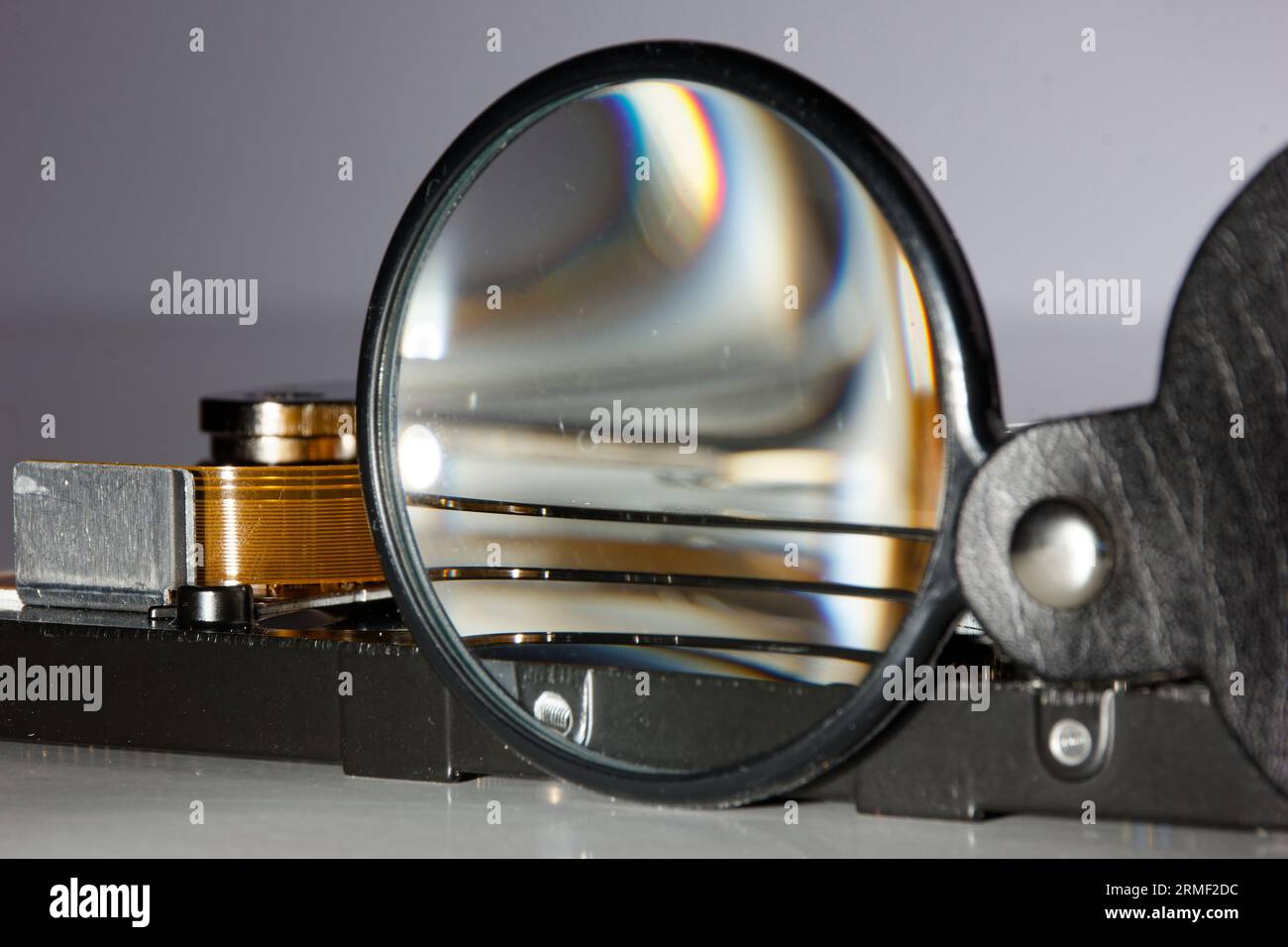 hard drive and magnifying glass, representing the process of searching ...