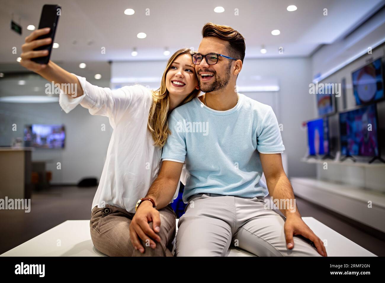 Couple is making selfie using a smart phone. Digital device, artificial intelligence concept. Stock Photo