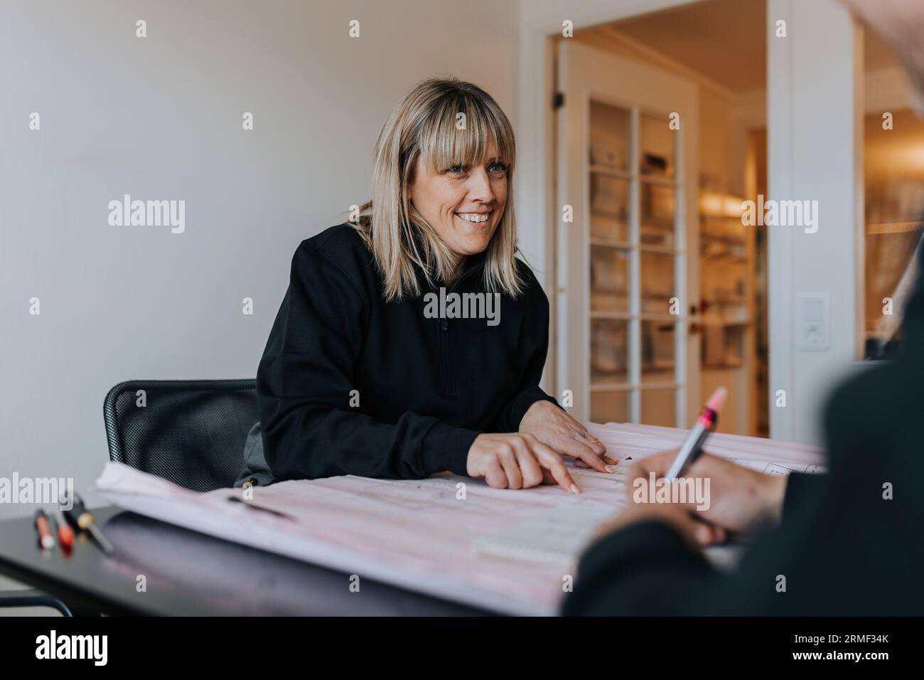 Smiling engineers working on plans Stock Photo