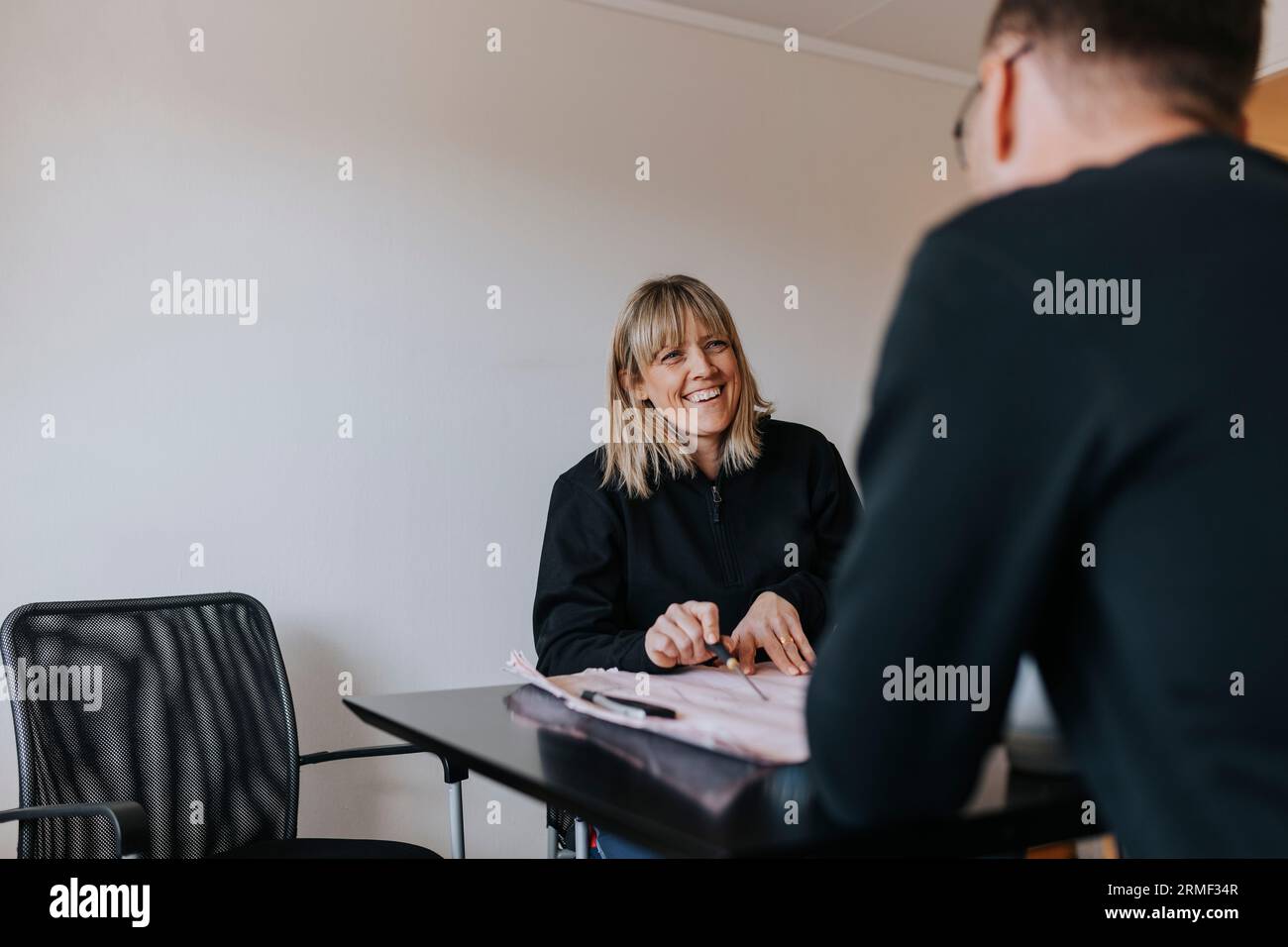 Smiling engineers working on plans Stock Photo