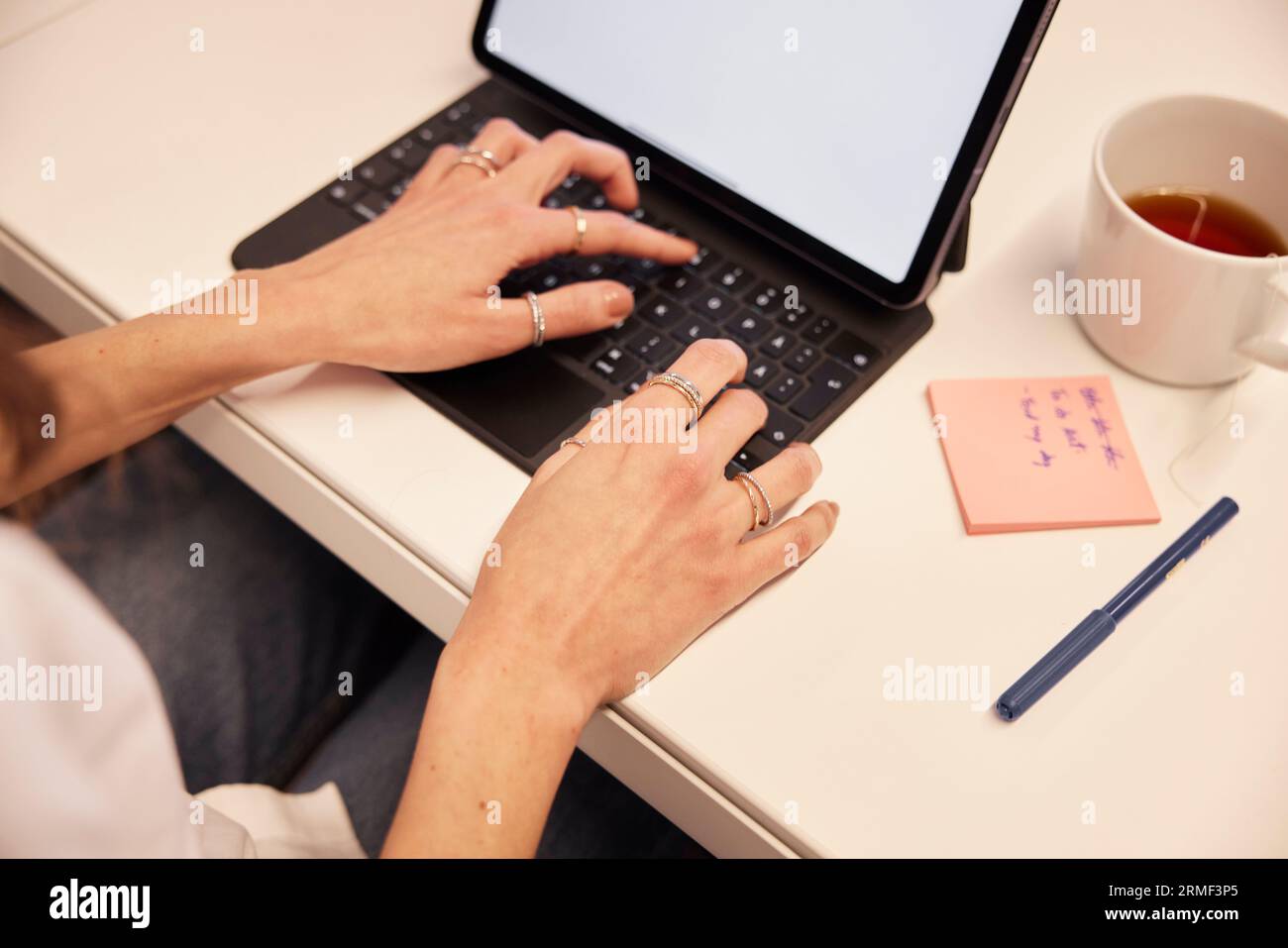 High angle view of woman's hands using laptop Stock Photo