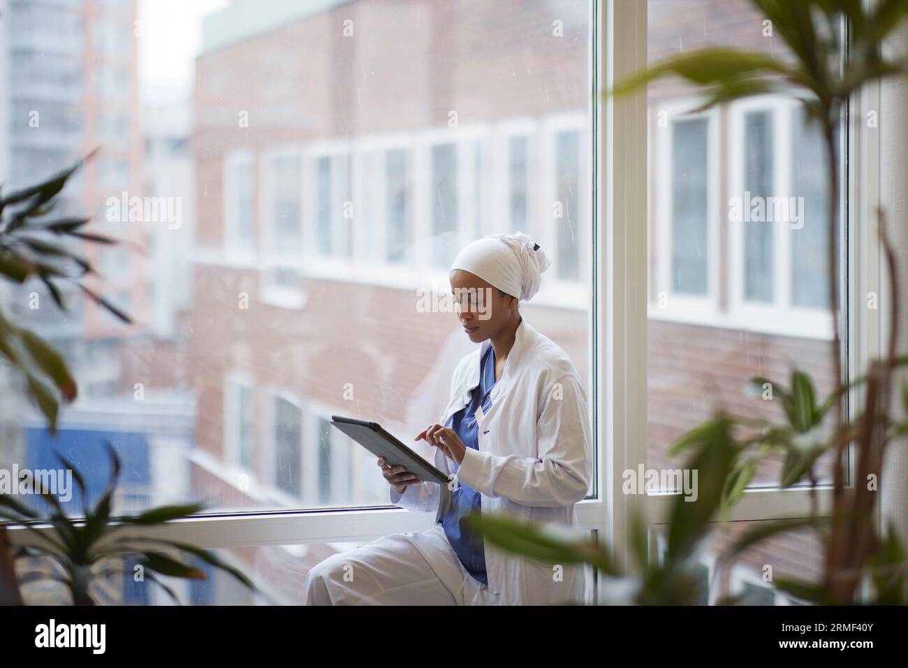 Female doctor standing and using digital tablet Stock Photo