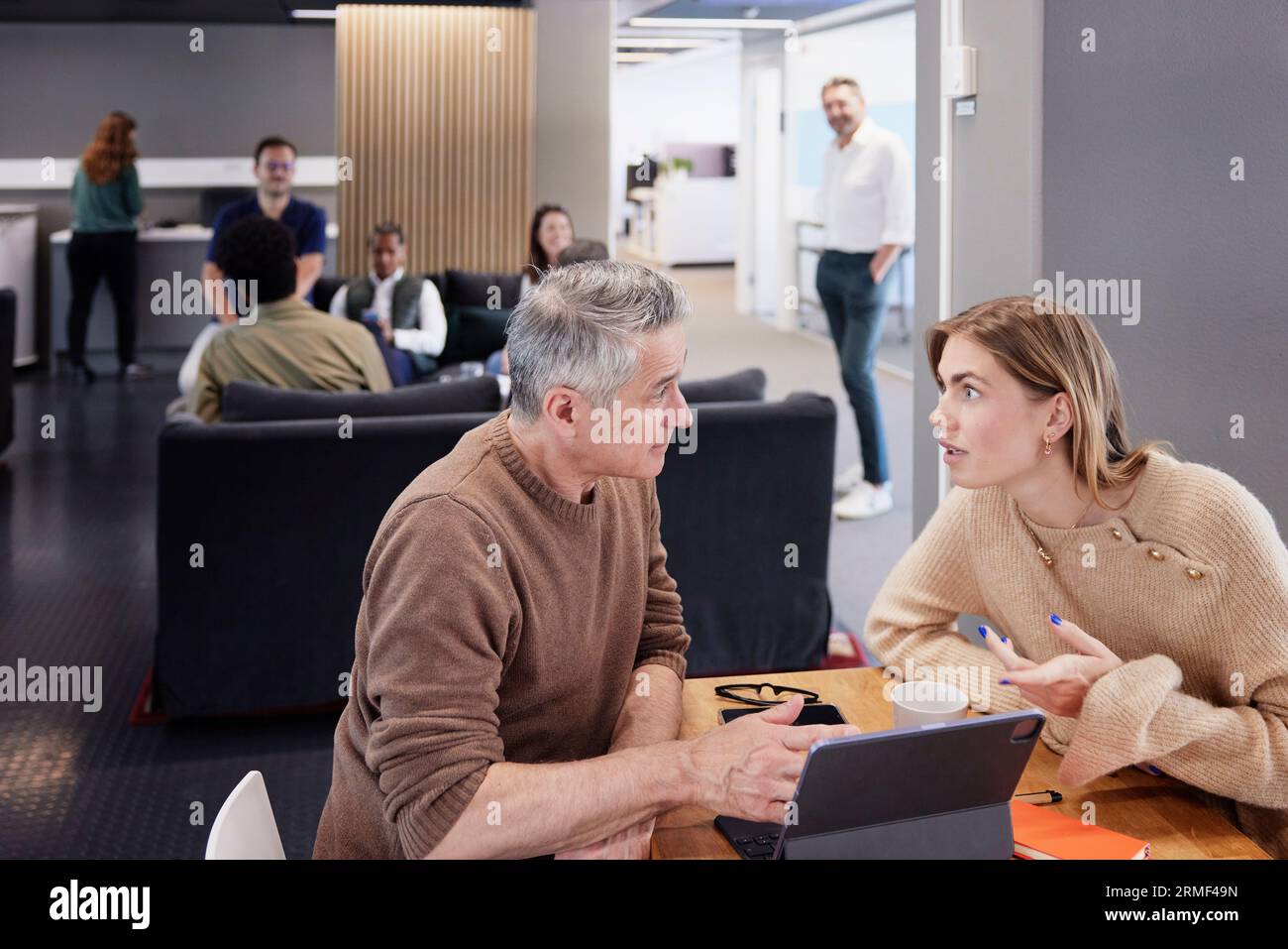 Two professionals working together in office cafeteria Stock Photo