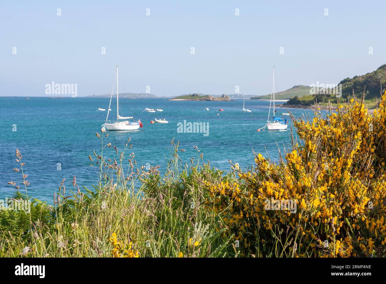 Yachts on their moorings in Green Bay on Bryher, Isles of Scilly, UK