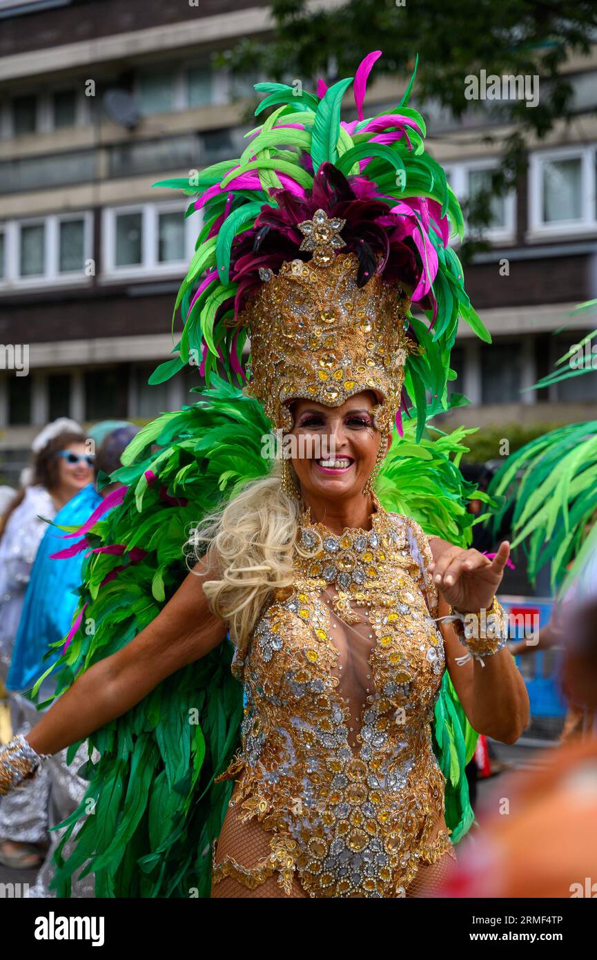 Notting Hill Carnival Monday, dancers in colourful costumes enjoy this sunny day Stock Photo