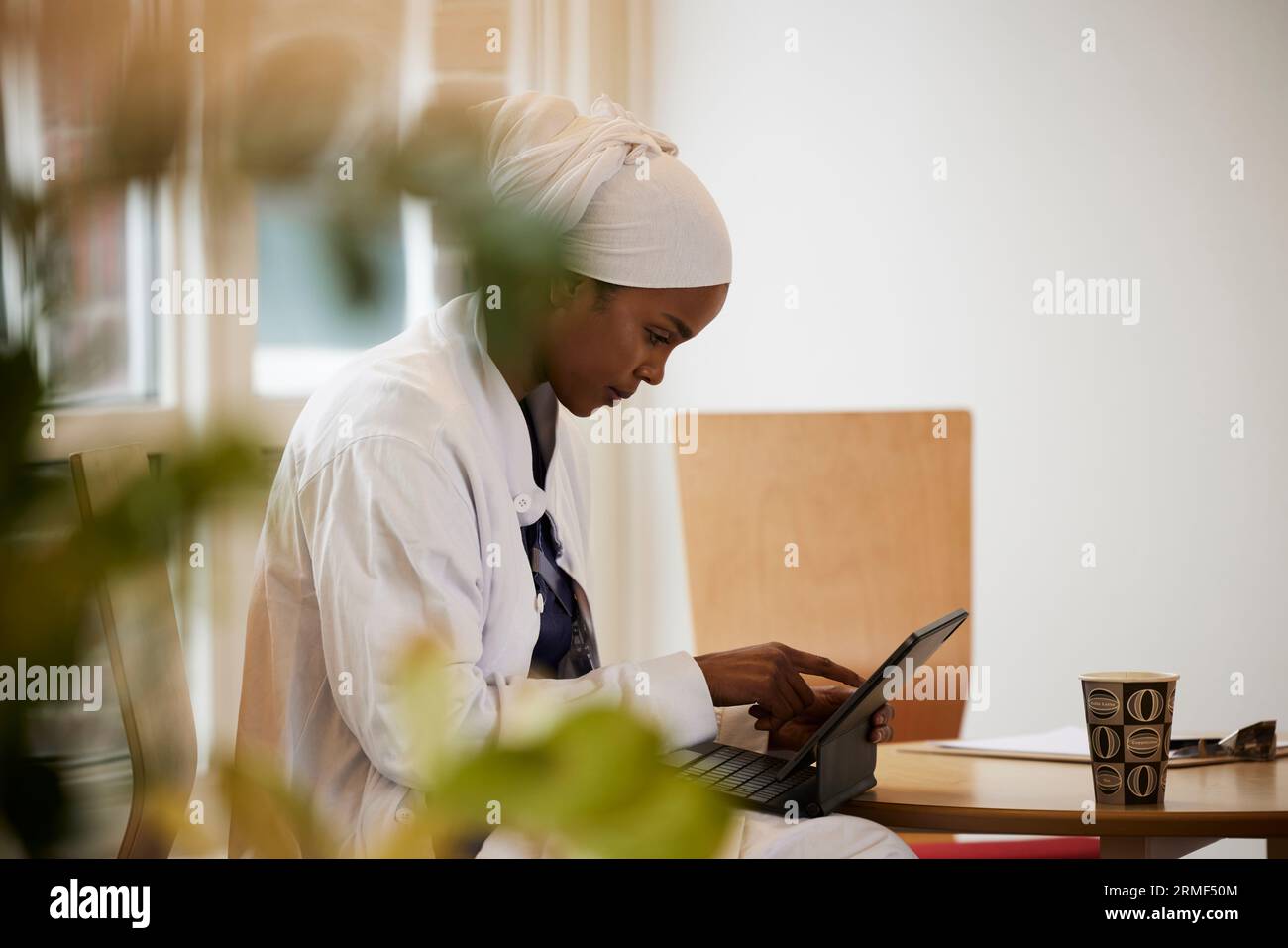 Young female doctor using tablet at work Stock Photo